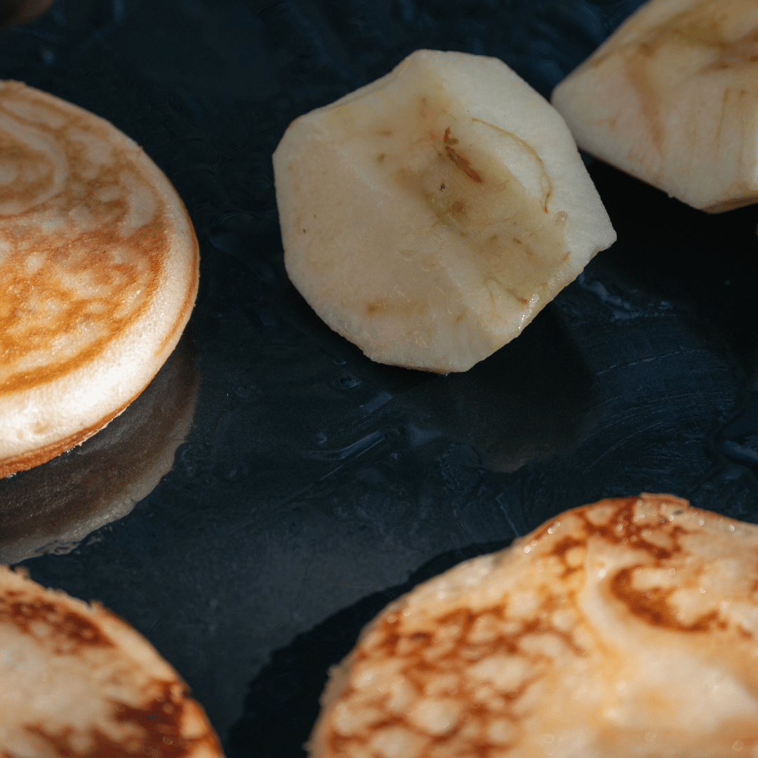 apple with pancakes on griddle