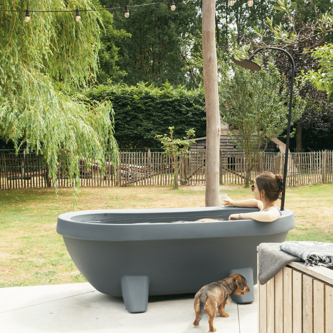 Bañera de hidromasaje antracita con grifo negro señora en bañera con perro salchicha