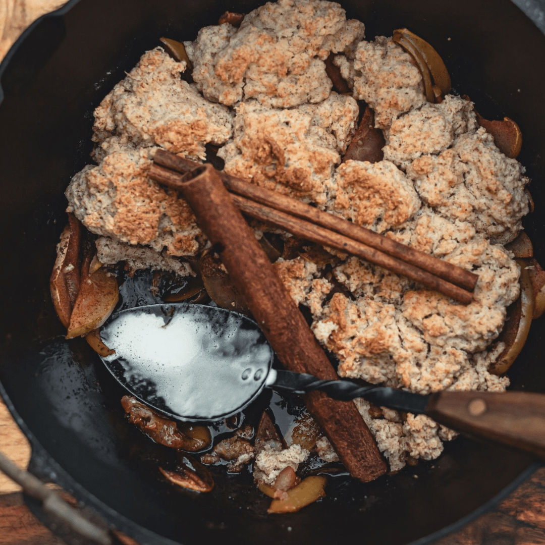Dutch oven with campfire apple pie and cinnamon sticks